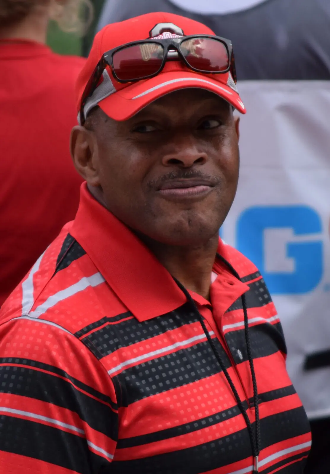 Archie Griffin wearing an Ohio State cap and polo shirt at an outdoor event in 2015