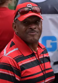 Archie Griffin wearing an Ohio State cap and polo shirt at an outdoor event in 2015