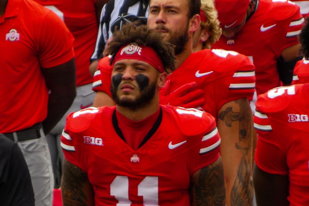 Brandon Inniss in a scarlet number 11 Ohio State jersey and headband on the sideline