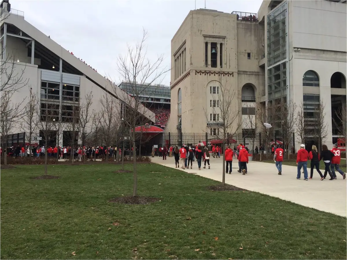 Fans in scarlet walking toward Ohio Stadium on an overcast November gameday