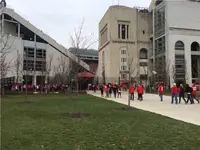 Fans in scarlet walking toward Ohio Stadium on an overcast November gameday