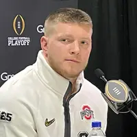 Jack Sawyer in a white Ohio State quarter-zip at a College Football Playoff media day podium