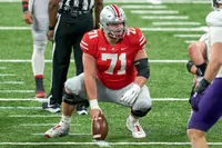 Ohio State center Josh Myers sets over the ball at the line of scrimmage