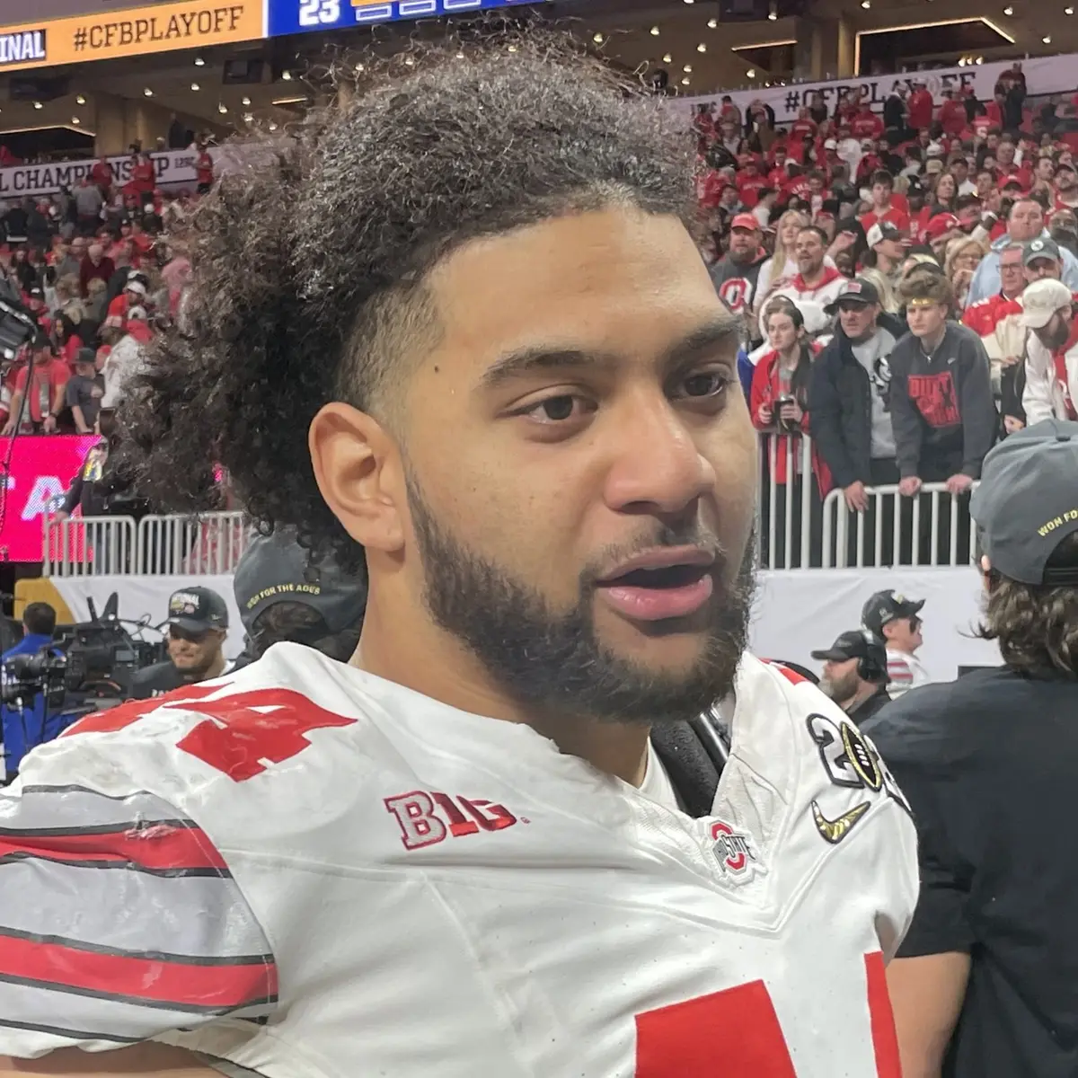 JT Tuimoloau in Ohio State uniform during the CFP national championship celebration