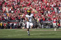 Ohio State and Michigan players on the field during the 2022 rivalry game