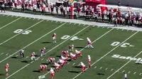 A wide view from the stands of two football teams lined up at the line of scrimmage during the Ohio State game at Nebraska