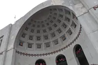 The rotunda facade at Ohio Stadium seen from below, with fans standing in the arched openings