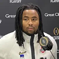 Tyleik Williams in a white Ohio State quarter-zip at a College Football Playoff media day podium