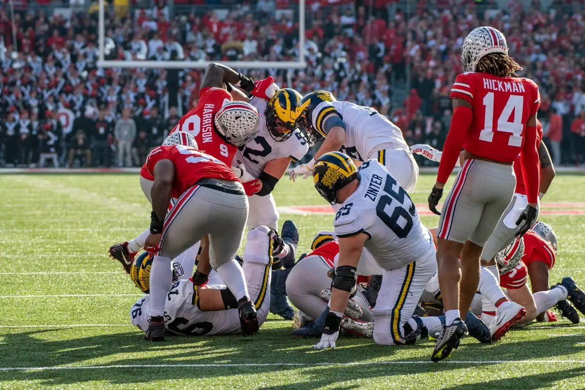 Ohio State defensive end Zach Harrison in scarlet at the top of a goal-line pile of Michigan and Ohio State players